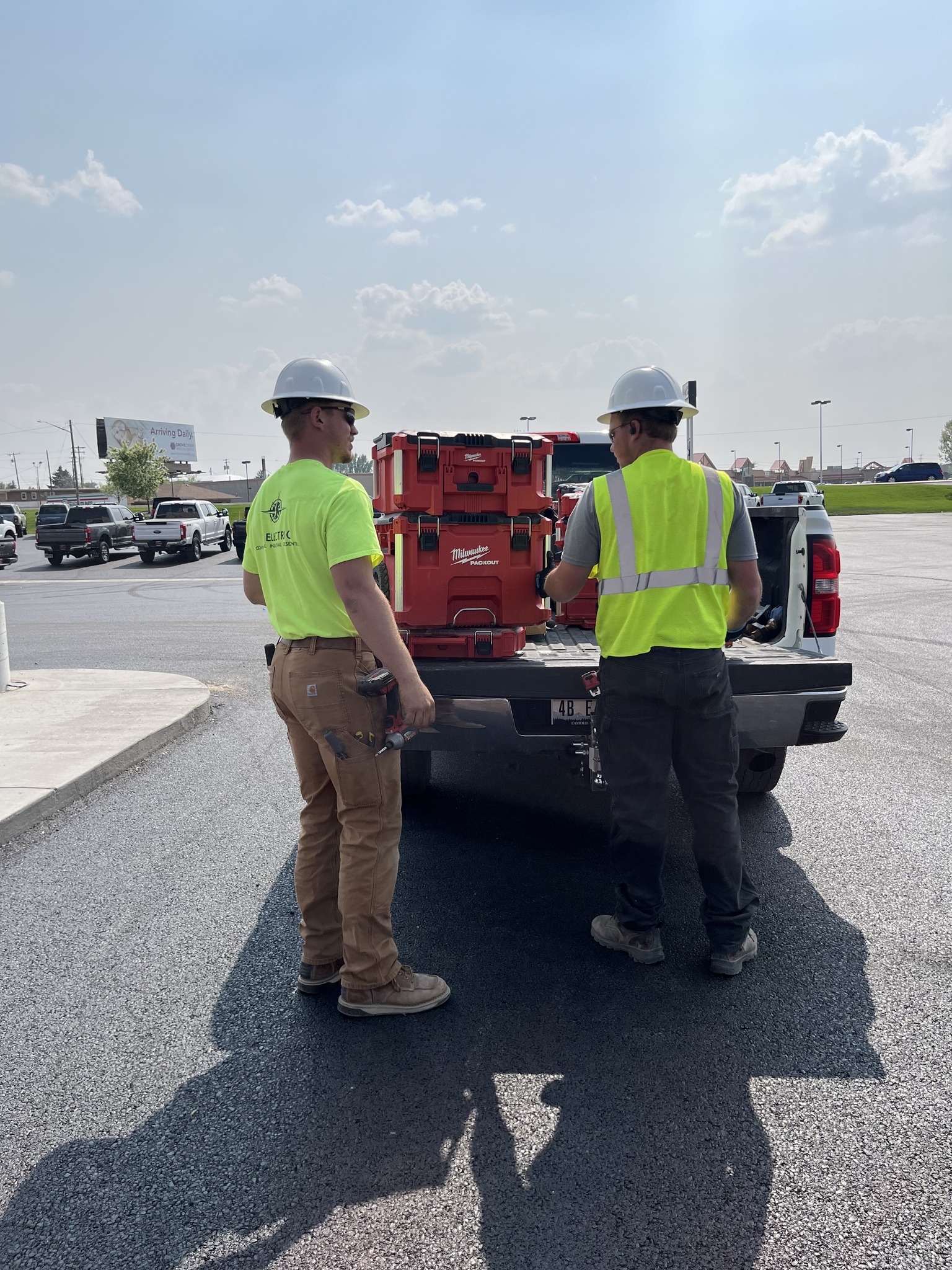 DL Electric Idaho employees standing in front of DL Electric company truck with tools